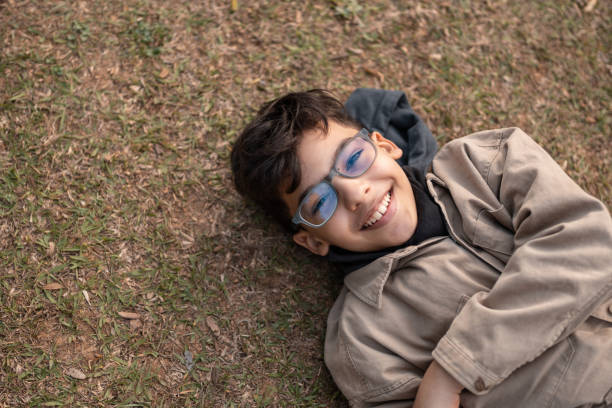 istock Portrait of a boy lying on the floor 1348010287