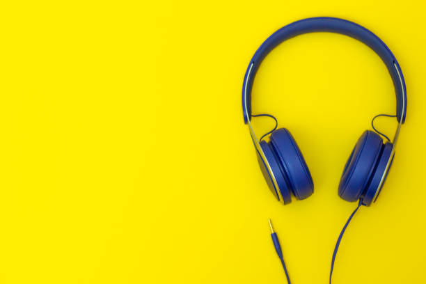 istock Blue music headphones on yellow background 1348014370