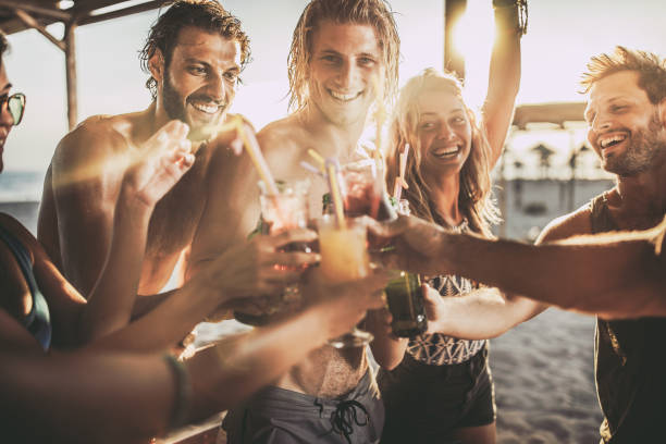 istock Happy friends toasting with alcohol in summer day. 1348014399
