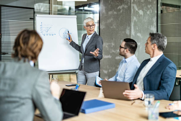 istock Mature CEO talking to her team during a presentation in the office. 1348016456