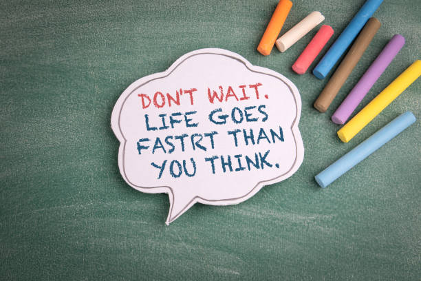 istock Dont wait. Life goes faster than you think. Speech bubble on a chalk board 1348016954