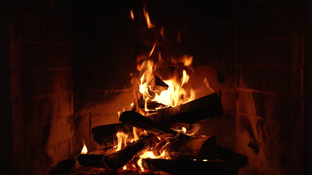 Burning Fire In The Fireplace. Slow Motion. A Looping Clip of a Fireplace with Medium Size Flames