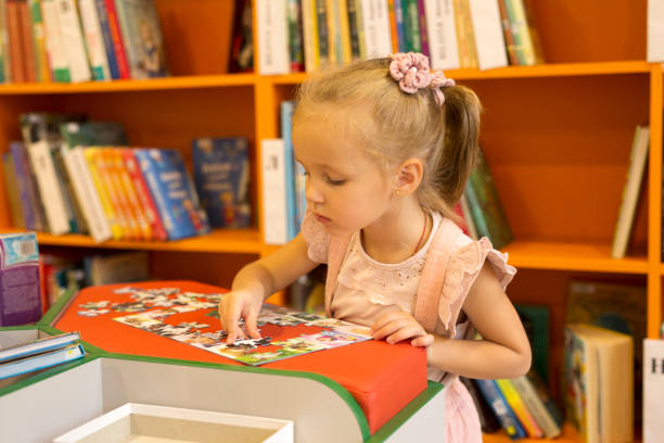 istock Little girl in the library 1348019340