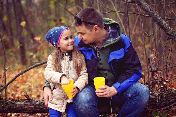 istock Father and daughter drinking tea in the autumn forest 1348022344