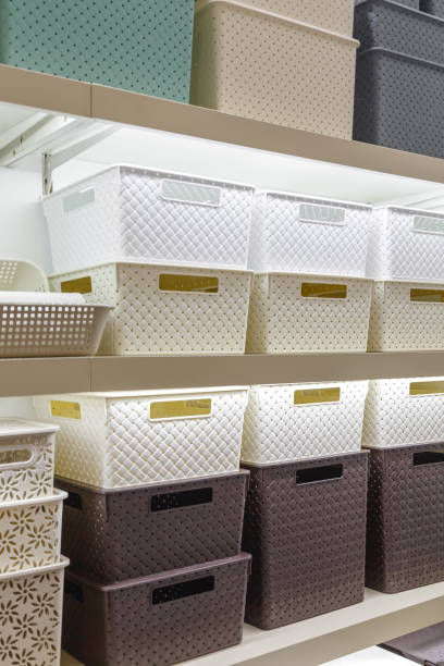 istock Plastic container boxes on a shelf on a rack for organizing home space and storing things, order and interior, selling household goods. Industrial background. 1348024114