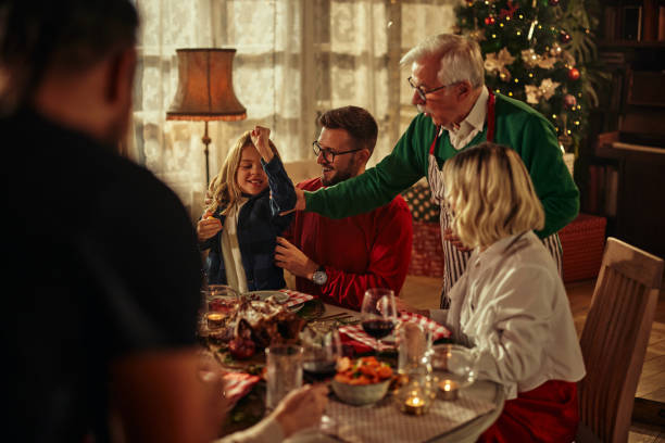 istock Happy extended family having New Year's lunch at dining table. 1348024391