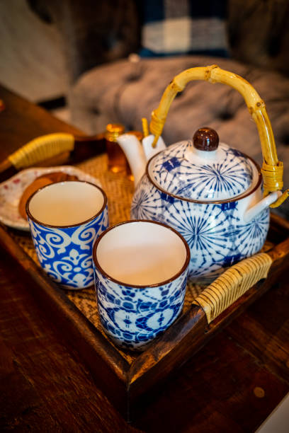 istock Close focus on striped blue and white ceramic cup with set of kettle. 1348025182