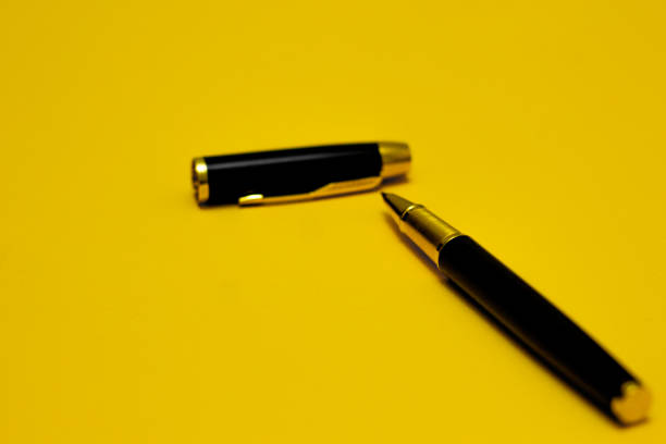 Yellow ballpoint pen isolated on white background