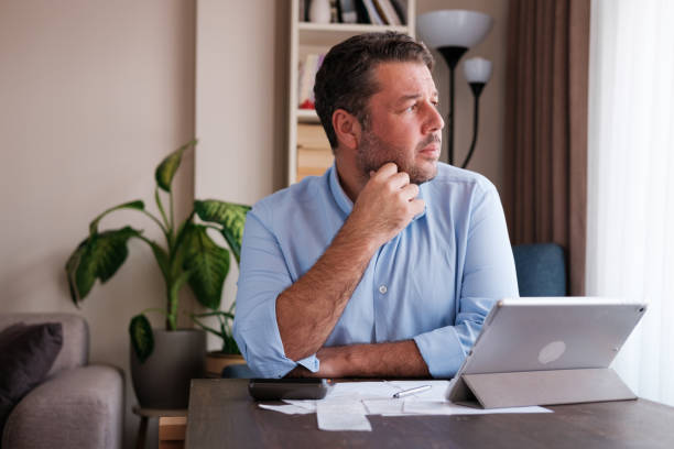 istock Man calculating personal expenses at home 1348027545