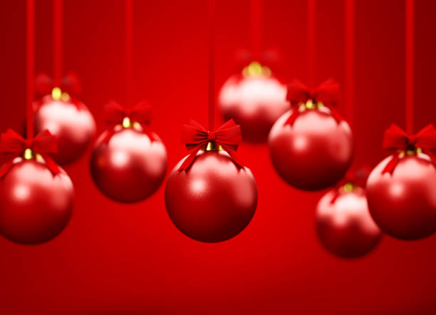 istock Red Christmas Baubles Hanging Over Red Background 1348027991
