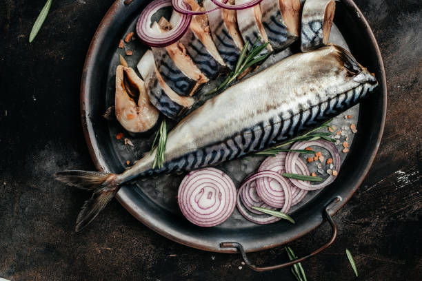 istock marinated mackerel or herring fish with onion on a metal tray. Seafood concept. top view 1348028197
