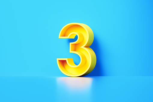 Yellow number three sitting on blue background. Horizontal composition with copy space.