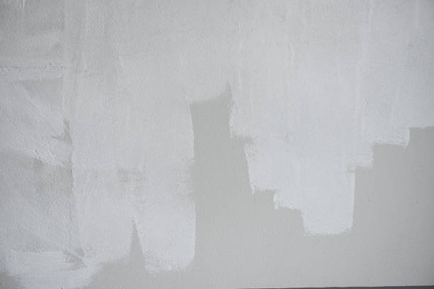 istock Painted wall background, Painter painting a house wall with a paint poller 1348030400
