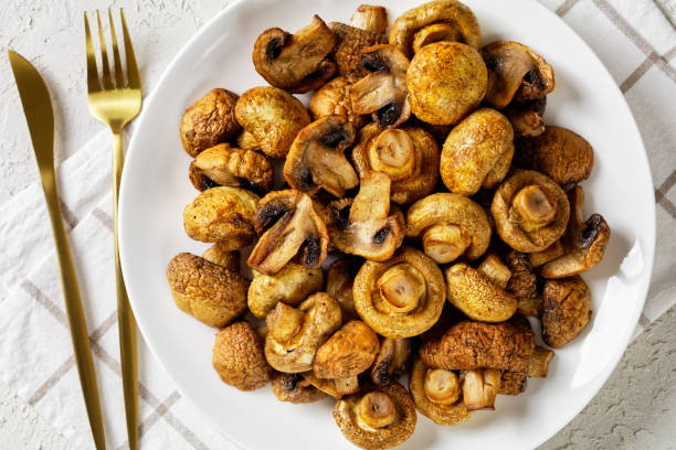 istock grilled juicy mushrooms on a plate on a white textured table, horizontal view from above, flat lay, close-up 1348030410