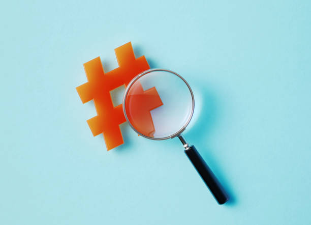 istock Magnifier And Hashtag Symbol On Aquamarine Background 1348030530