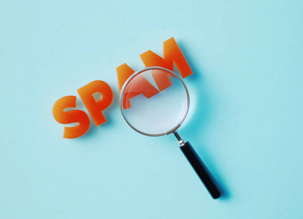 istock Magnifier And Spam Text On Aquamarine Background 1348030541