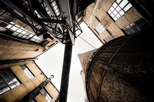 Old red brick buildings and tall industrial chimneys photographed in Chengdu on cloudy days