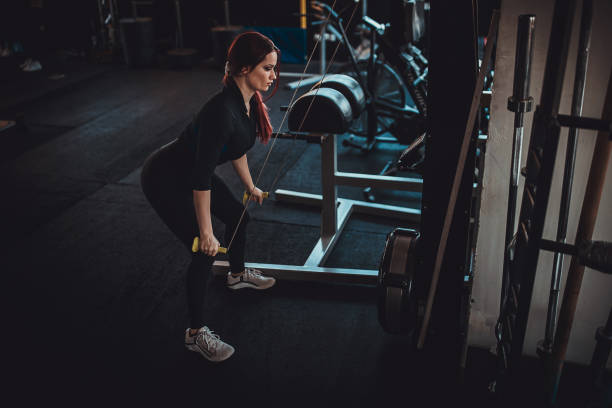 istock Young woman exercising in gym 1348030693