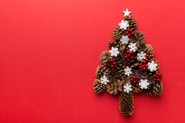 istock Christmas tree made from natural cones on colored background, view from above. New Year minimal concept with copy space 1348030881