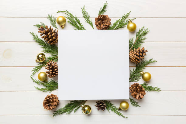 istock Flat lay Christmas composition. square Paper blank, pine tree branches, christmas decorations on Colored background. Top view, copy space for text 1348030929