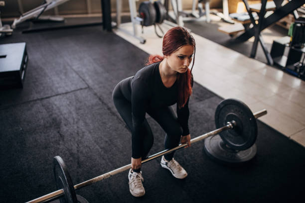 Young woman exercising with weights
