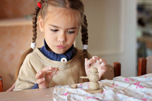 istock Education and art, kid playing with modeling clay in pottery workshop, craft and clay art 1348033110
