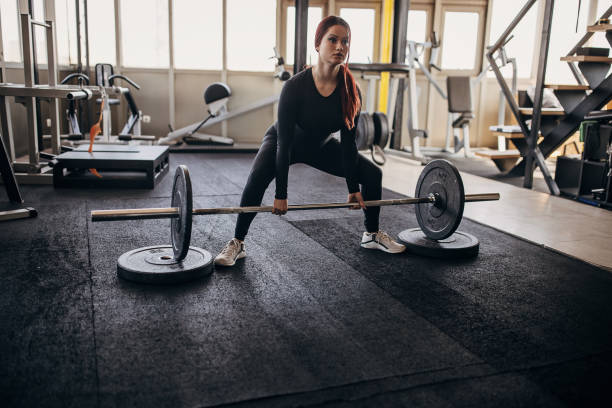 istock Young woman exercising with weights 1348033180