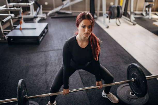 istock Young woman exercising with weights 1348033202