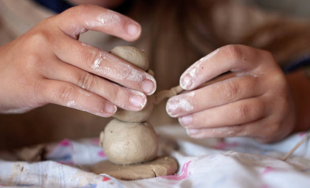 istock Education and art, kid playing with modeling clay in pottery workshop, craft and clay art 1348033229
