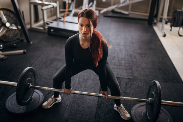 istock Young woman exercising with weights 1348033247
