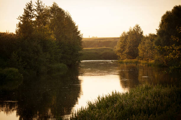 istock Beautiful summer landscape with a flowing river in the evening at sunset 1348036534