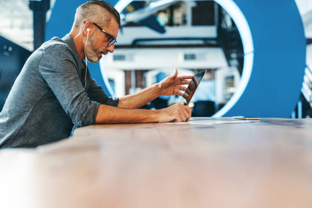 istock Mature businessman speaking during a virtual meeting in an office 1348037090