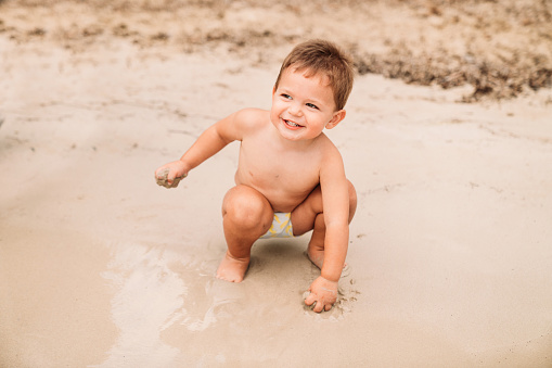 Baby boy enjoying the beach