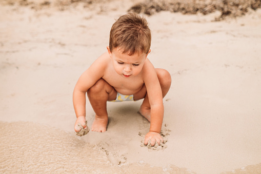 Baby boy enjoying the beach