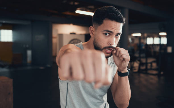 istock Shot of a young man practicing his punching in the gym 1348037836