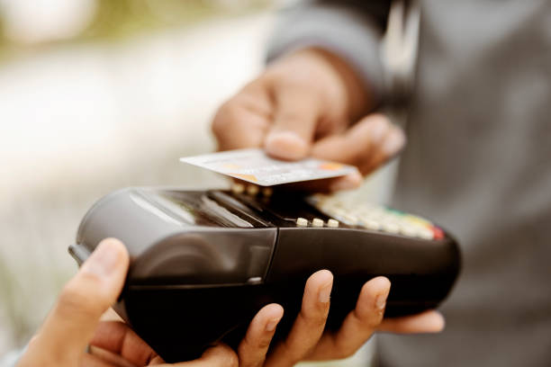 istock Man Paying for Flowers with his Debit Card 1348038410