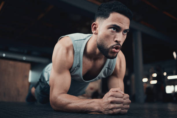 Shot of a handsome young man doing a plank