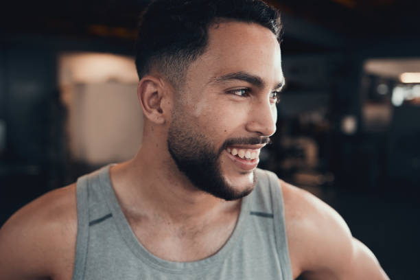 istock Shot of a young man taking a break during a gym workout 1348038668