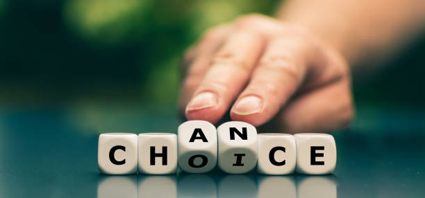 istock Hand turns dice and changes the word choice to chance. Symbol that every choice is also a chance. 1348039240