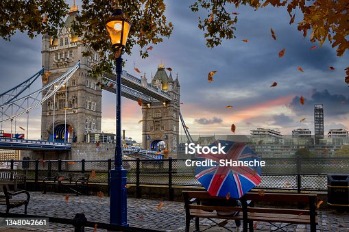 istock London in autumn time concept with a person holding a british umbrella sitting in front of Tower Bridge 1348042661