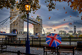 istock London in autumn time concept with a person holding a british umbrella sitting in front of Tower Bridge 1348042661