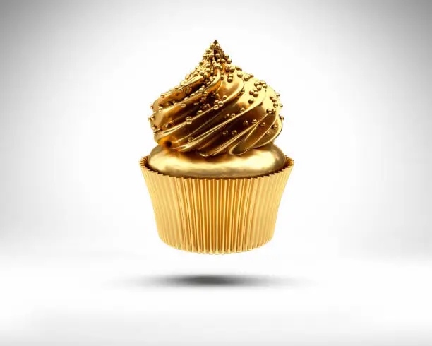 Golden cupcake floating on white background