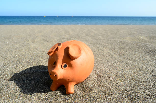 istock Coin Bank on Sand 1348042933
