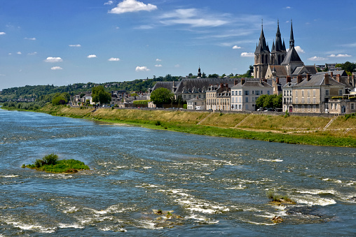 Ferry boat on Rhine river in the Rhine valley. Visible rocks and sandbars due to extraordinary low water level after a long period of drought in 2022.