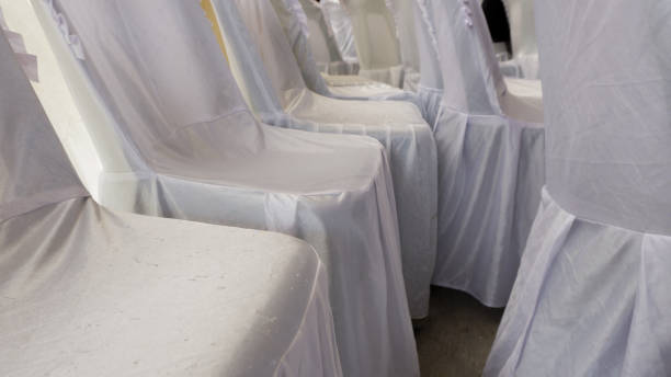 istock Empty white chairs at the wedding day. wedding ceremony chair decoration, covered with white fabric 1348046129