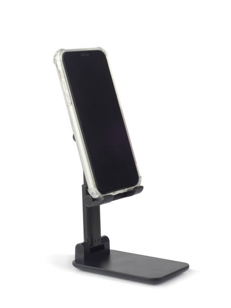 istock Smartphone with blank screen on black plastic holder isolated on white 1348047817