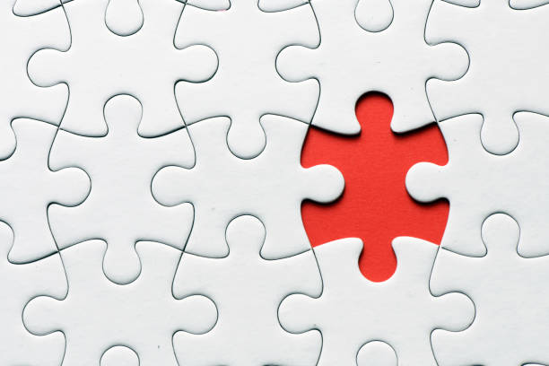 istock Red jigsaw puzzle pieces on red background. Copy space and business concept 1348049164