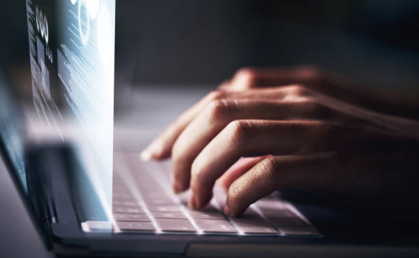 Cropped shot of an unrecognizable businesswoman sitting alone in her office at night and using her laptop Activating all online systems fx stock pictures, royalty-free photos & images