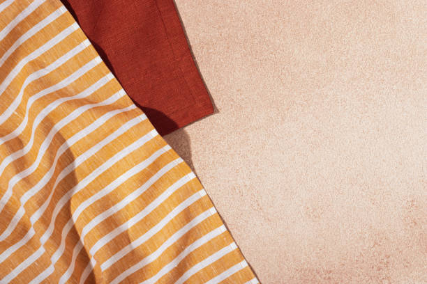 istock Stack of colored cloth serving napkins on beige plastered background 1348055242