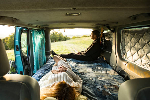 istock Young Couple Relaxing in Camper Van on a Trip 1348055899